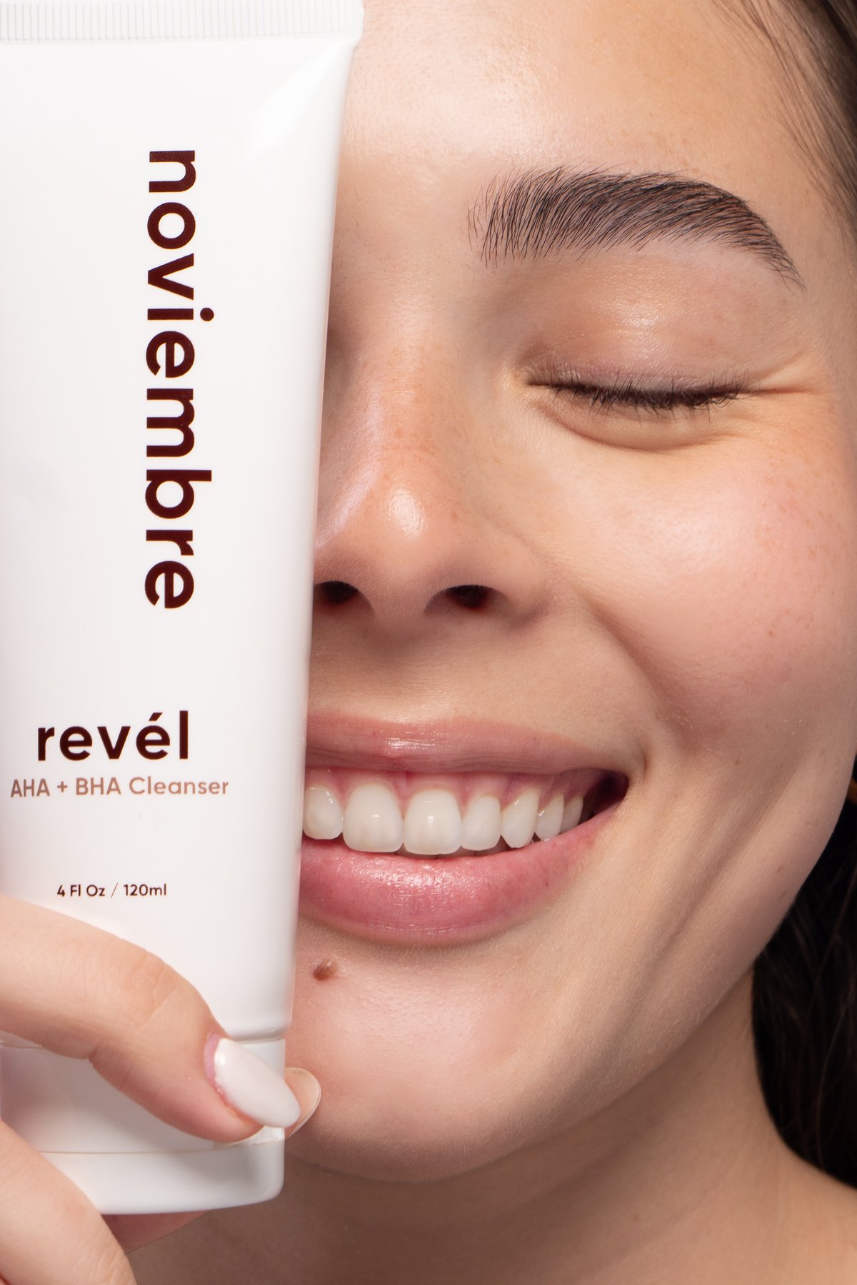 Rev&eacute;l en la mano, junto a la cara